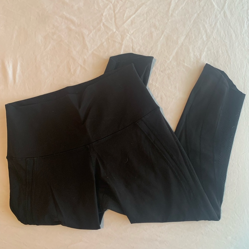 Cropped Lululemon leggings. Cutouts along legs.